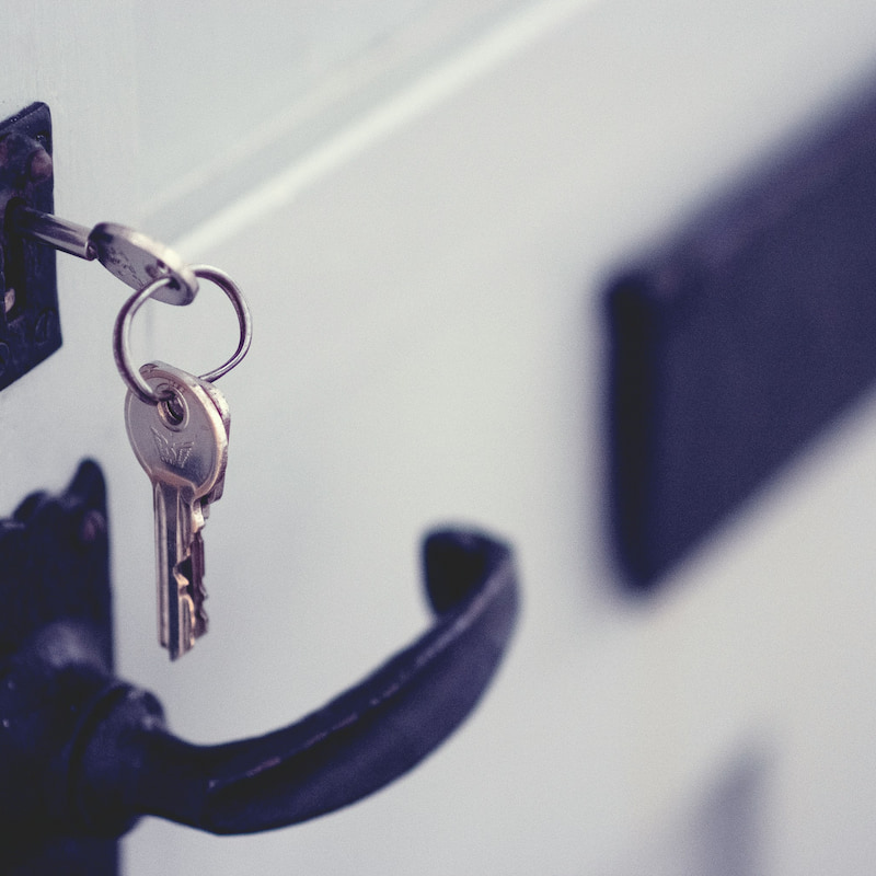 Front door with new set of keys in the lock after a replacement