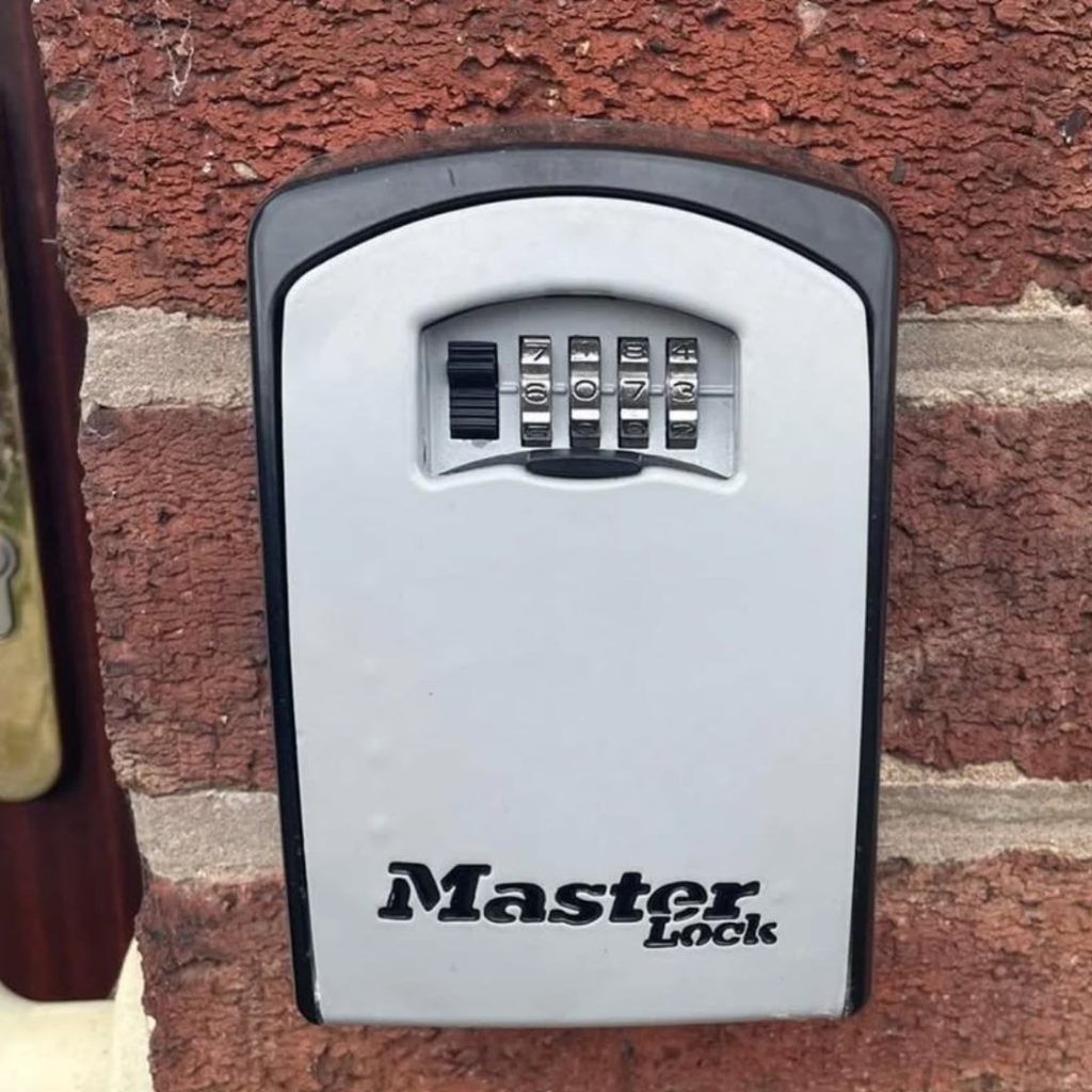 Master Lock key safe securely mounted near entrance.