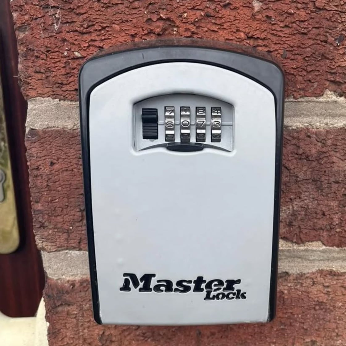 Master Lock key safe securely mounted near entrance.